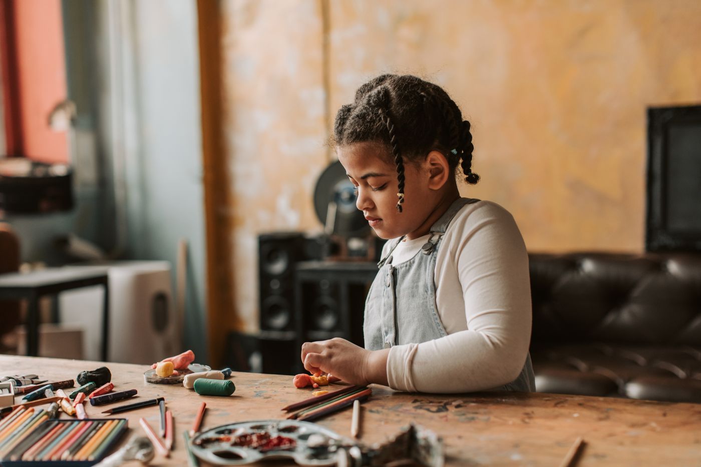 Young girl focused on a hands-on learning activity at a table