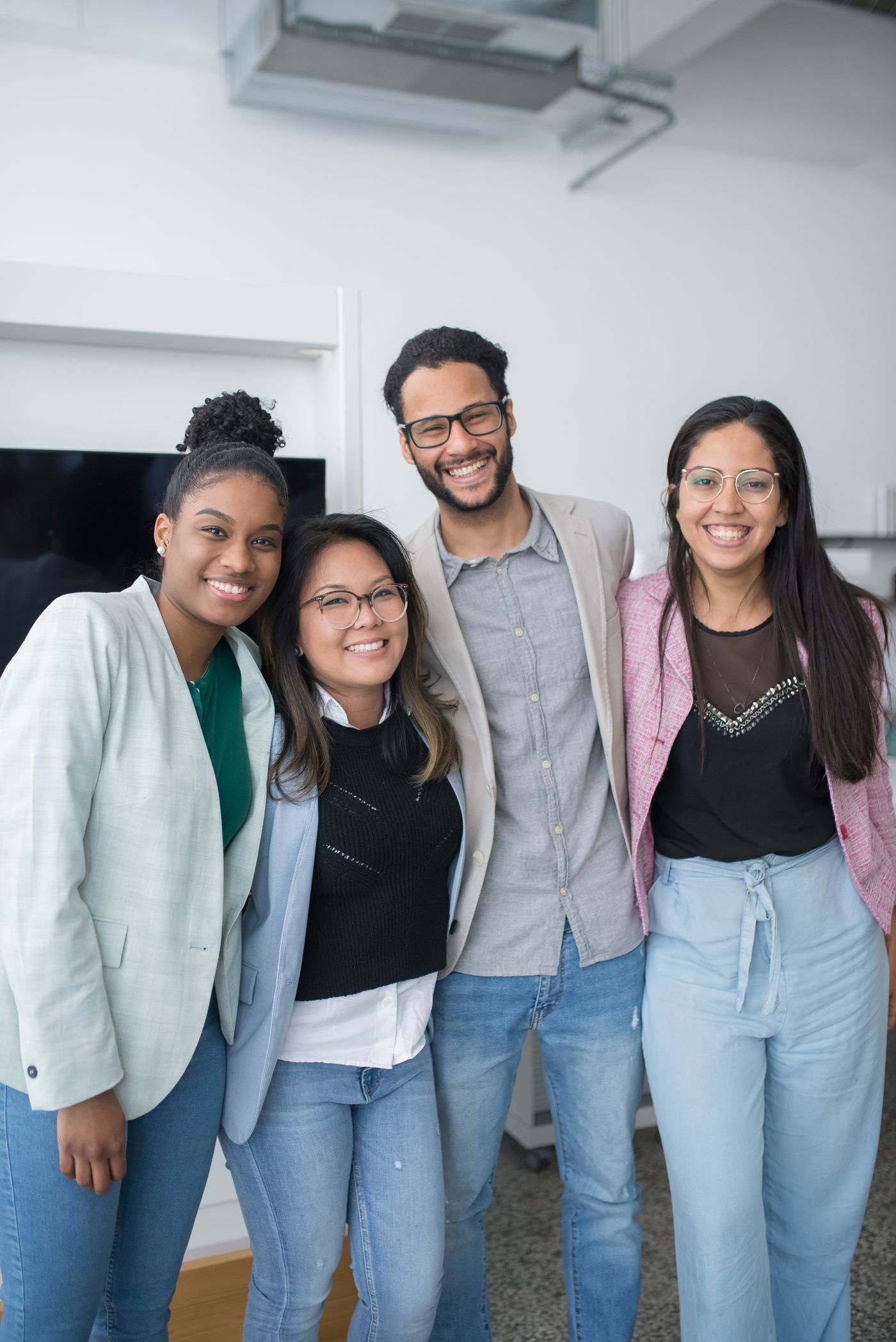 A small, friendly group of professionals smiling together